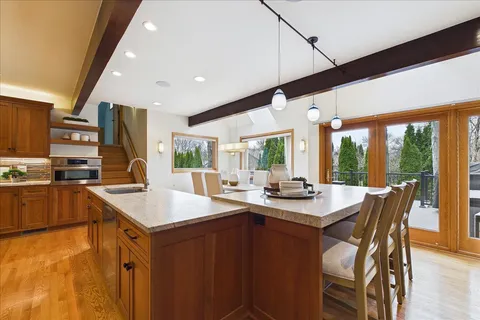 a kitchen with stainless steel appliances kitchen island granite countertop a sink and cabinets