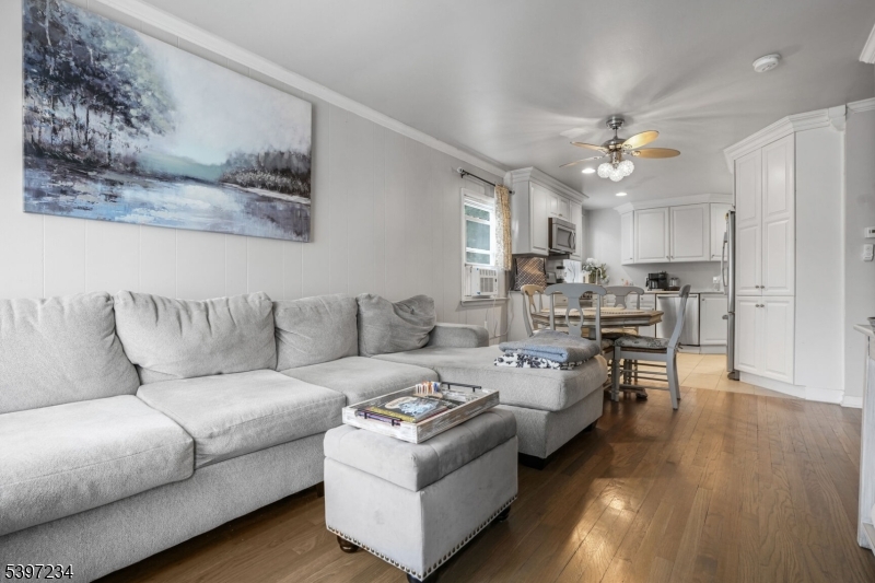 a living room with furniture and kitchen view