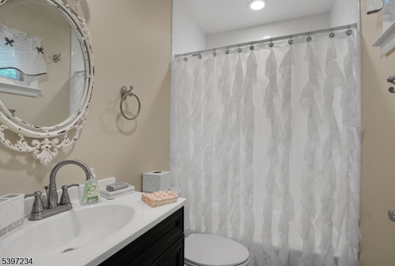 102 East Shore Road Denville, NJ 07834 - Photo 11 of 14 a bathroom with a sink and a mirror