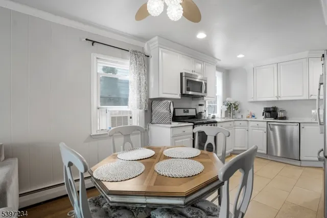 a kitchen with a dining table chairs and microwave