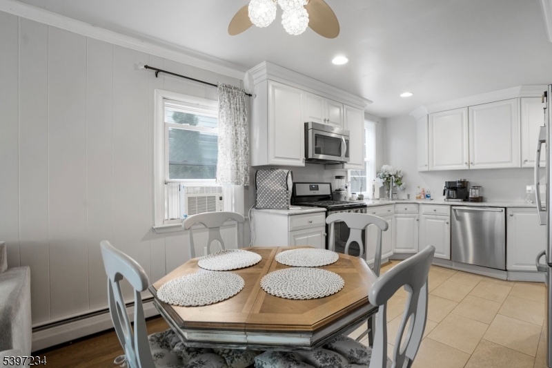 102 East Shore Road Denville, NJ 07834 - Photo 6 of 14 a kitchen with a dining table chairs and microwave