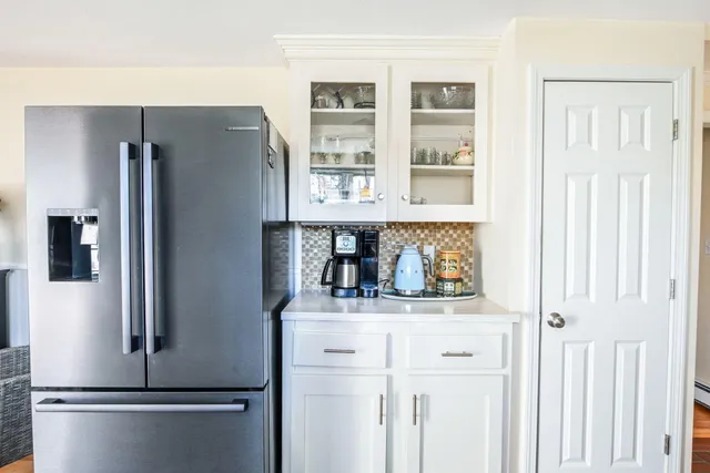 a kitchen with stainless steel appliances a refrigerator and cabinets