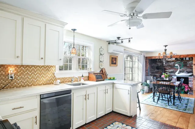 a kitchen with a sink cabinets and window