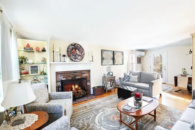 a living room with furniture fireplace and a fireplace