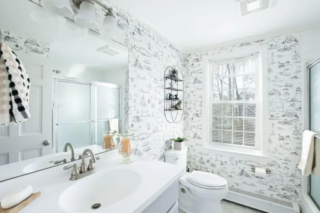 a bathroom with a sink toilet and shower