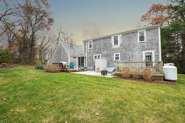 a view of a house with backyard and sitting area