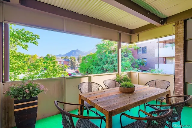 a view of a patio with table and chairs and potted plants