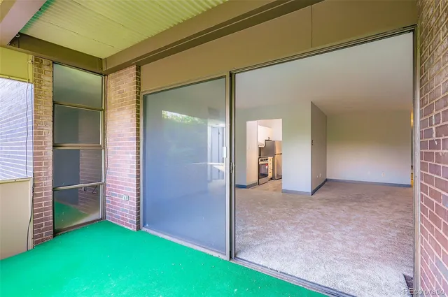 an empty room with closet and mirror