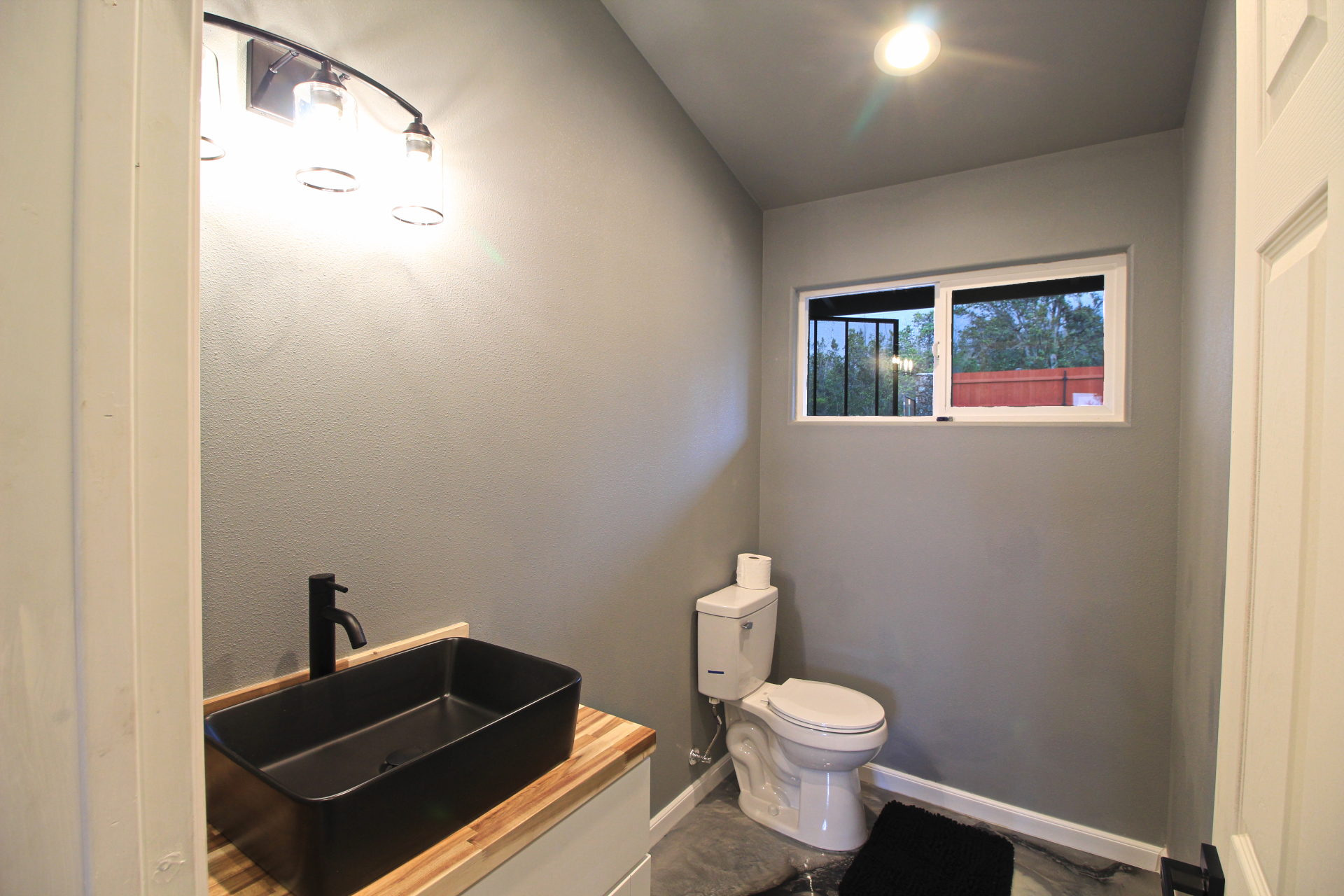 92-1920 Aloha Boulevard Ocean View, HI 96704 - Photo 18 of 26 a bathroom with a toilet and a sink