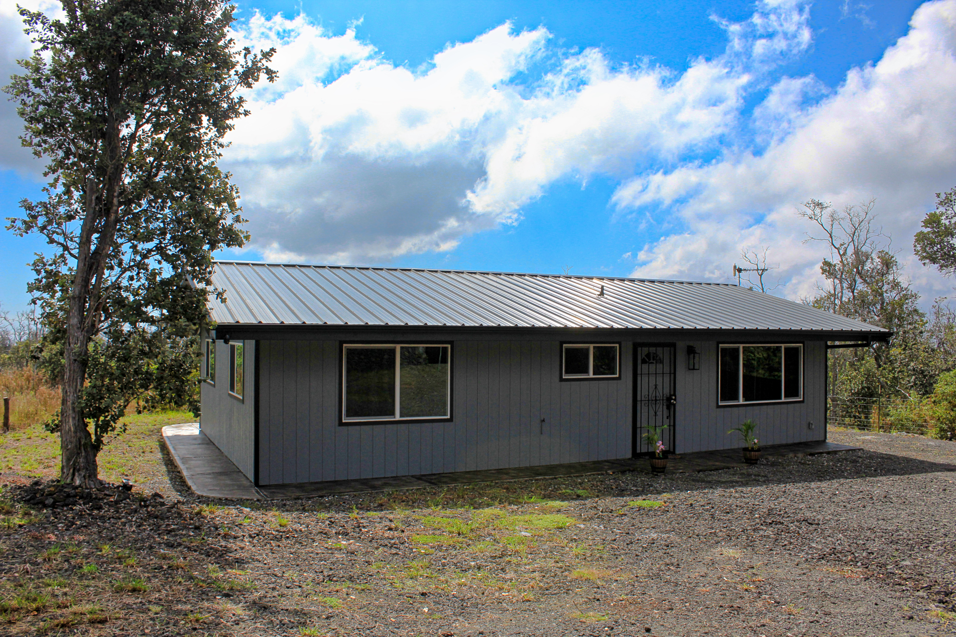 92-1920 Aloha Boulevard Ocean View, HI 96704 - Photo 2 of 26 a view of a house with a backyard