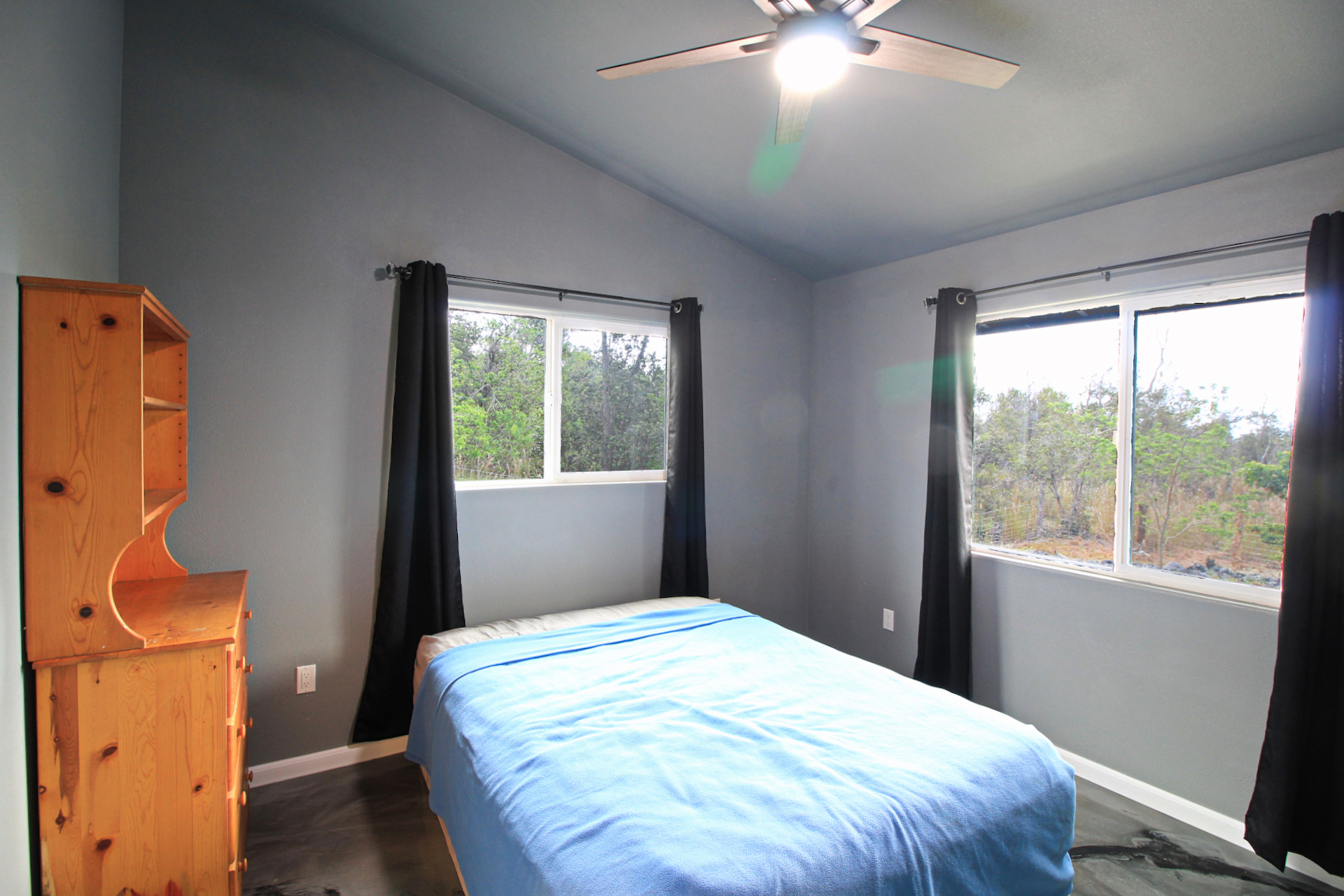 92-1920 Aloha Boulevard Ocean View, HI 96704 - Photo 22 of 26 a bedroom with a bed and a window