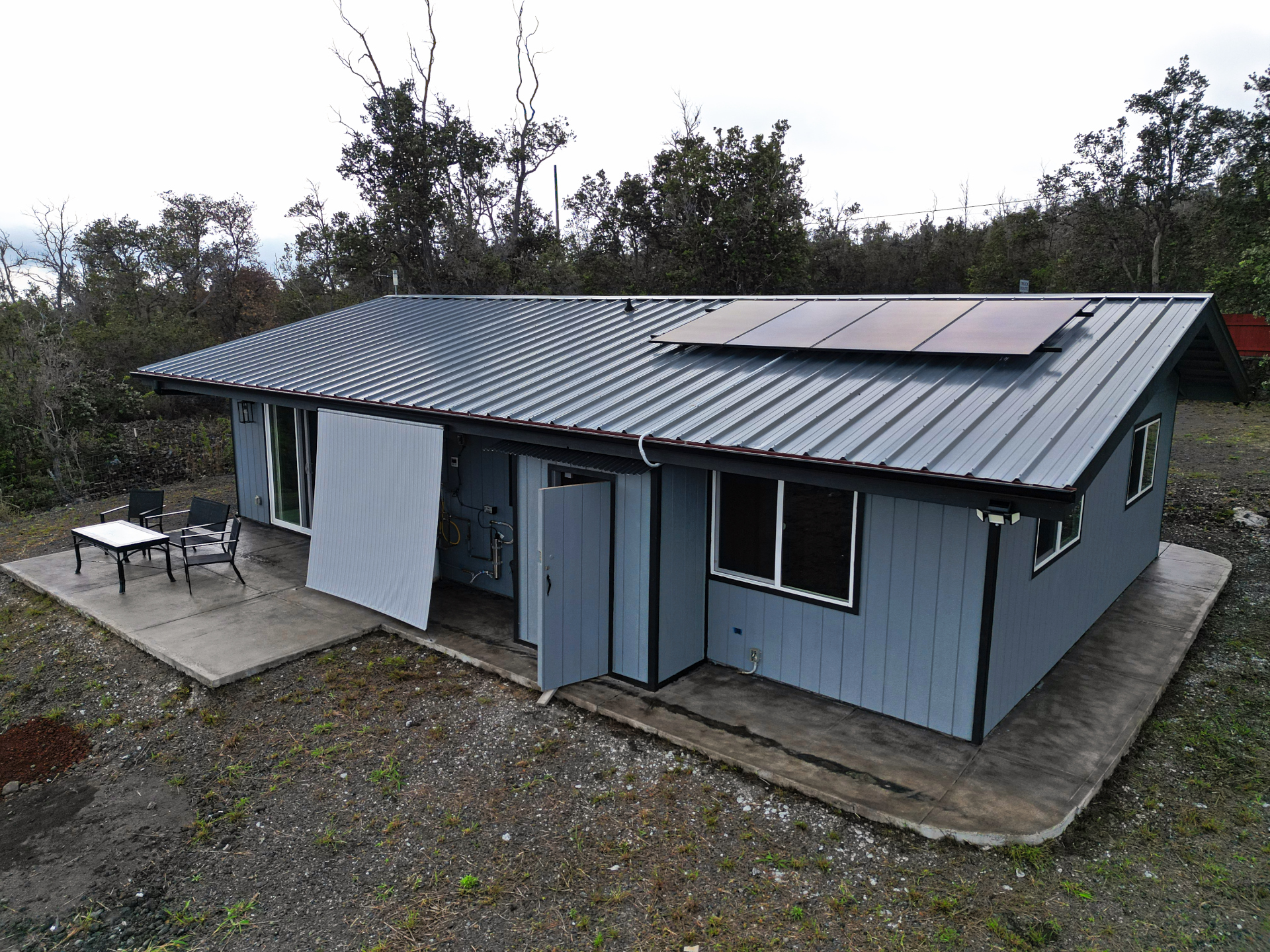 92-1920 Aloha Boulevard Ocean View, HI 96704 - Photo 7 of 26 a backyard of a house with table and sofas