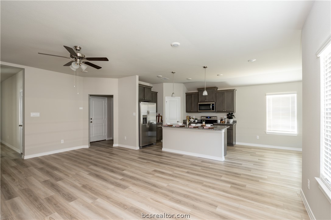 2159 Chief Street Bryan, TX 77807 - Photo 4 of 22 a view of a kitchen with a sink and a stove top oven with wooden floor