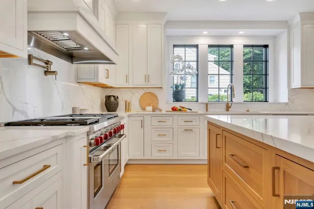 a kitchen with stainless steel appliances granite countertop a stove and a sink