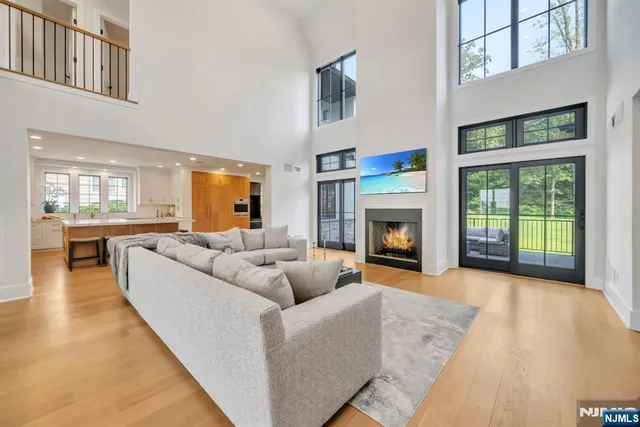 a living room with furniture large window and a fireplace