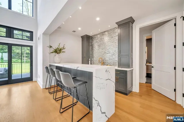a dining room with furniture and a floor to ceiling window