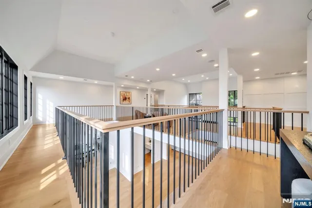 a view of a hallway with wooden floor