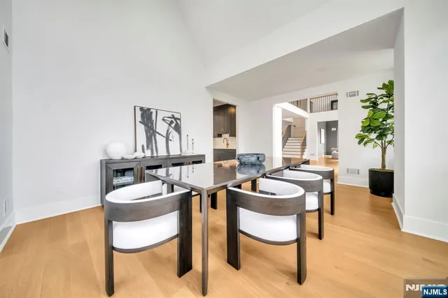 a dining room with furniture and a wooden floor