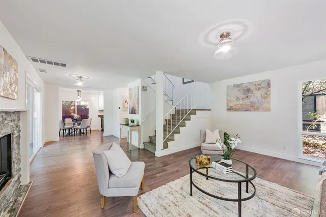 a living room with furniture kitchen view and a fireplace