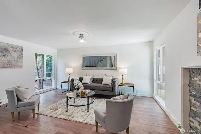 a living room with furniture and a wooden floor