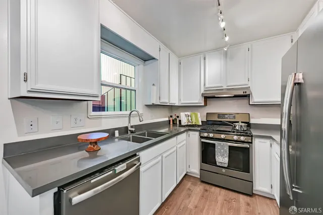 a kitchen with a sink stove and refrigerator