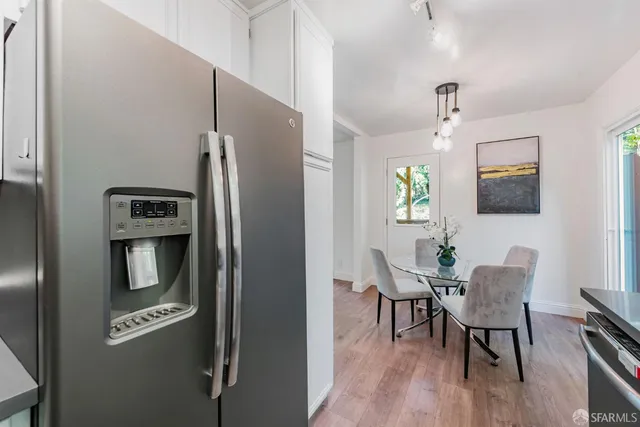 a kitchen with stainless steel appliances granite countertop a sink and a stove