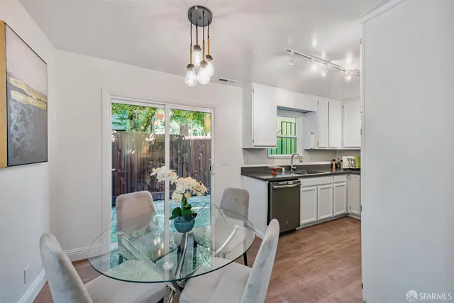 a kitchen with granite countertop white cabinets and stainless steel appliances