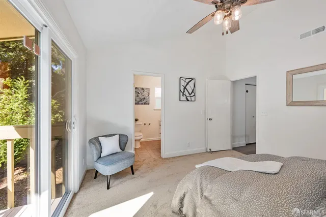 a spacious bedroom with a bed and a large window