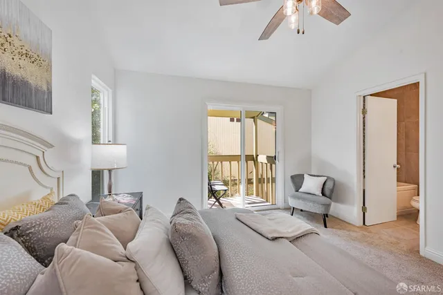 a bedroom with a bed lamp and window