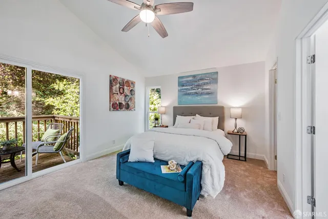 a bedroom with a large bed and a chandelier