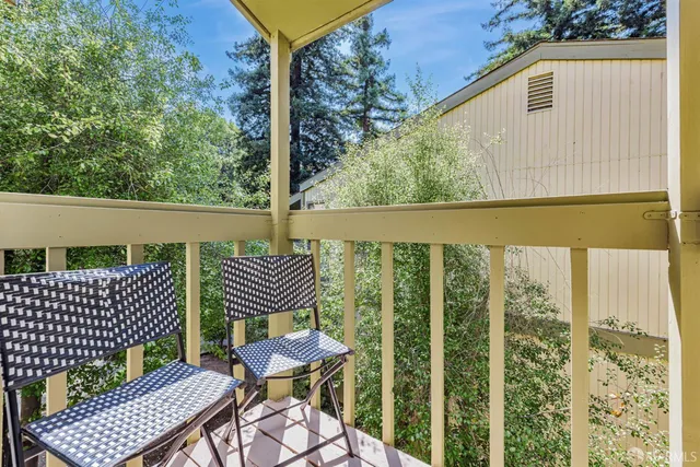 a backyard of a house with lots of green space and chair