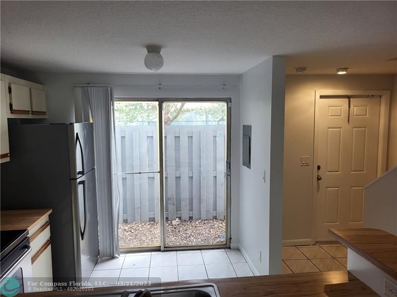 197 Southwest 3rd Street, Unit 197 Pompano Beach, FL 33060 - Photo 7 of 28 a view of entryway with wooden floor and cabinets
