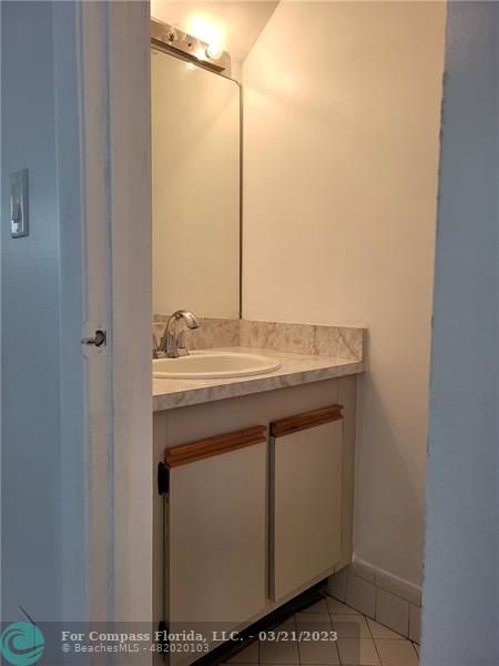 197 Southwest 3rd Street, Unit 197 Pompano Beach, FL 33060 - Photo 8 of 28 a bathroom with a sink vanity and a mirror
