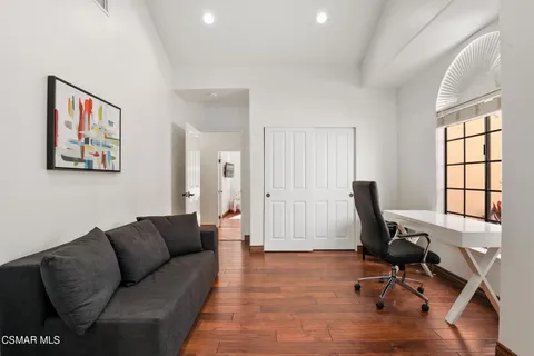 a view of livingroom with workspace and a couch