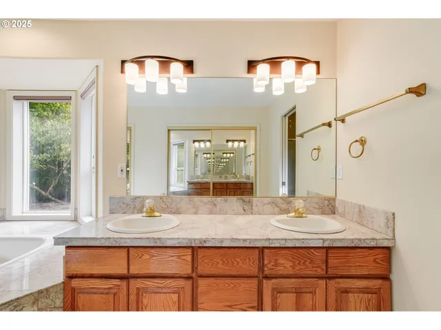 a bathroom with a sink double vanity and a mirror