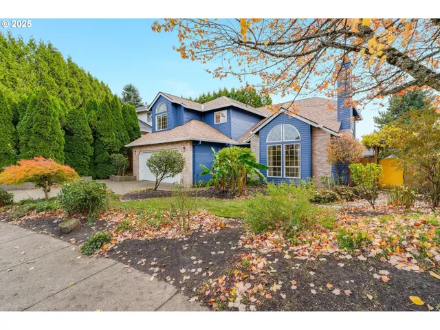 a front view of a house with a garden