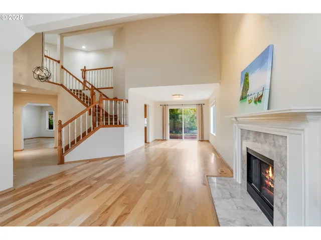 a view of empty room with wooden floor and fireplace