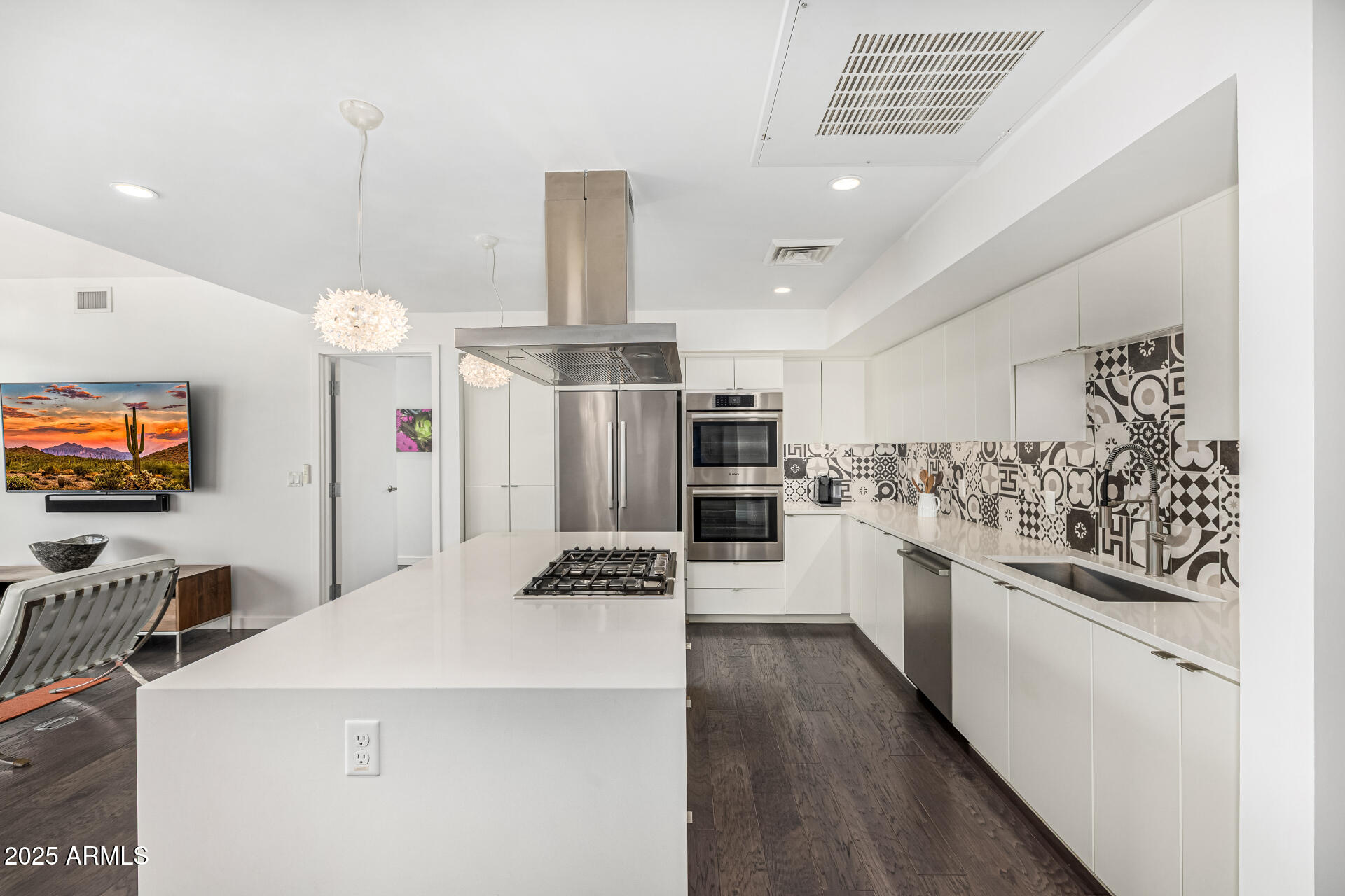 200 West Portland Street, Unit 827 Phoenix, AZ 85003 - Photo 10 of 111 a kitchen with stainless steel appliances kitchen island granite countertop a refrigerator a stove a sink dishwasher and white cabinets with wooden floor