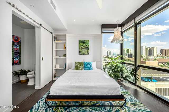 a bedroom with a large bed and a book shelf