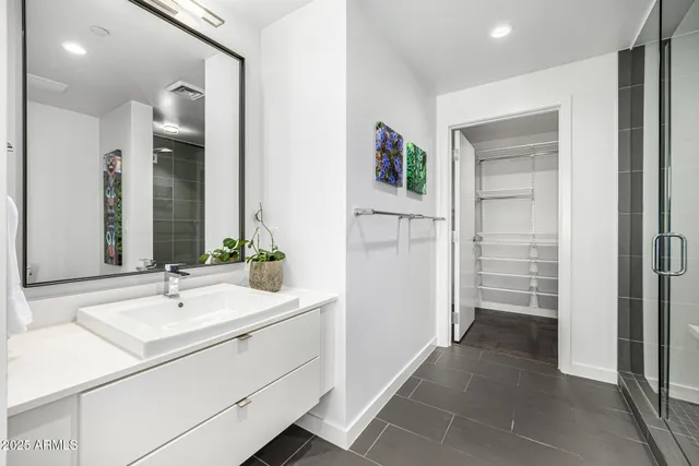 a view of a hallway with mirror and a bathroom