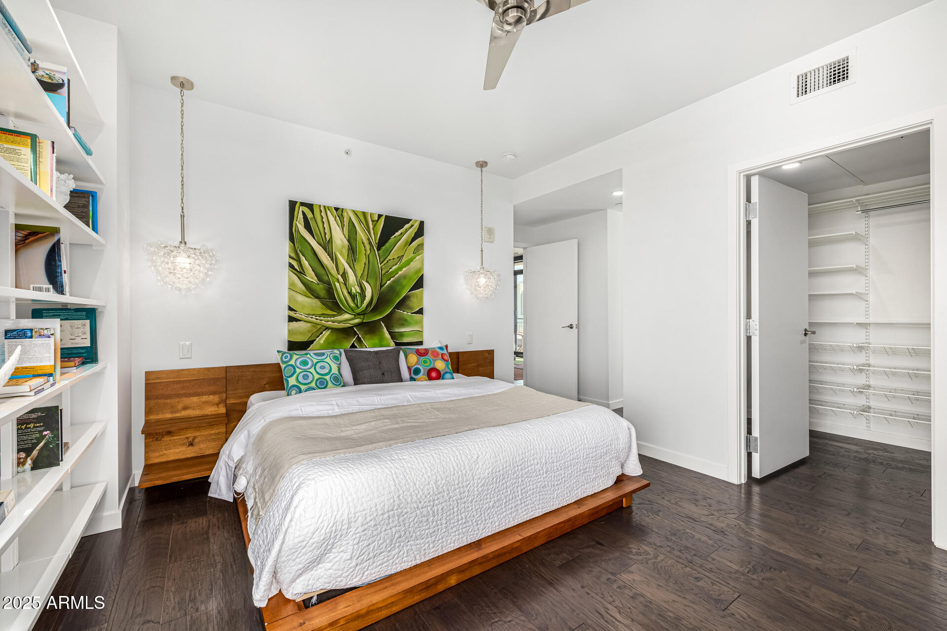200 West Portland Street, Unit 827 Phoenix, AZ 85003 - Photo 21 of 111 a bedroom with a bed a dresser and wooden floor