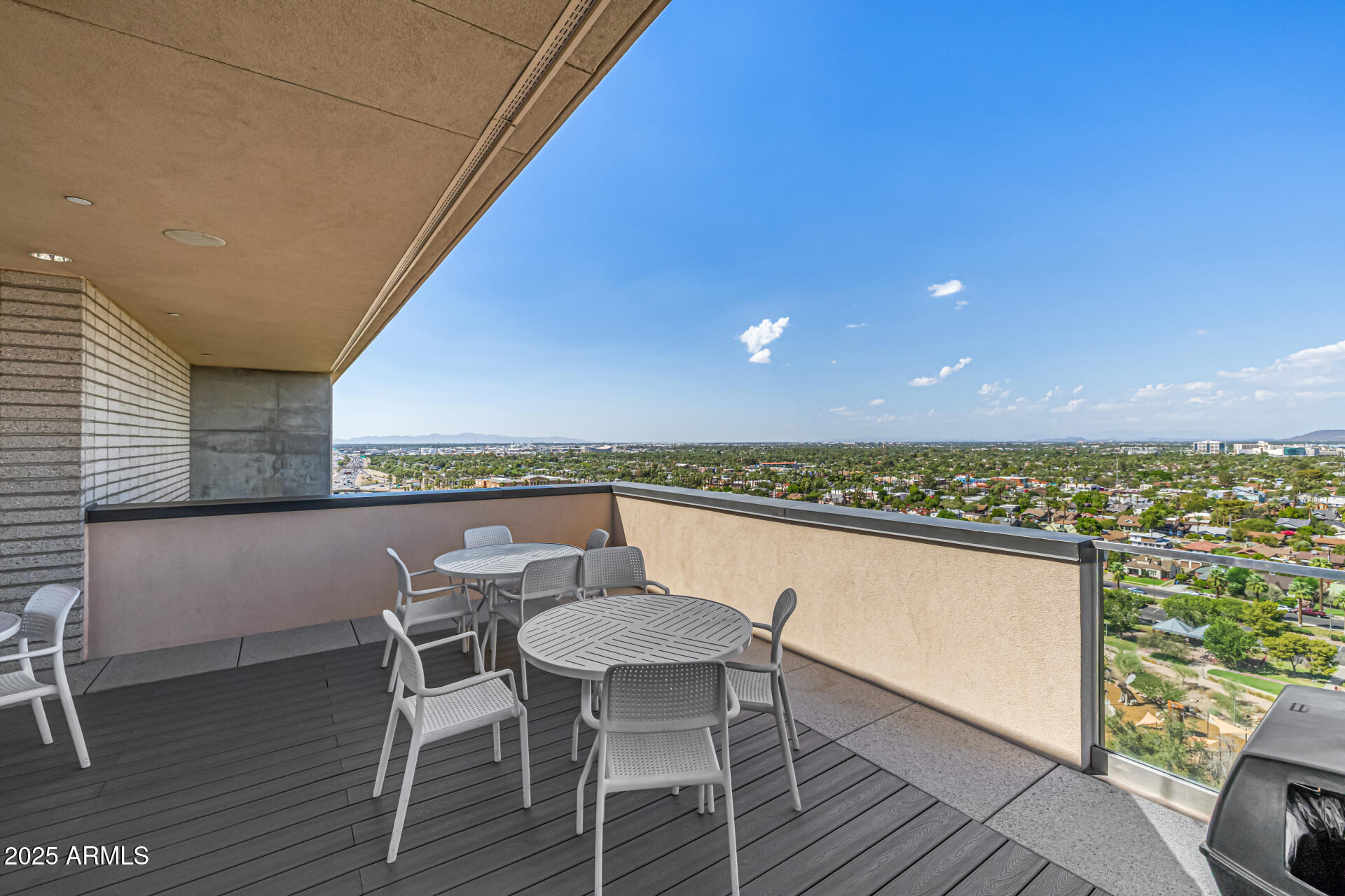 200 West Portland Street, Unit 827 Phoenix, AZ 85003 - Photo 57 of 111 a view of a chairs and table on wooden deck with a lake view