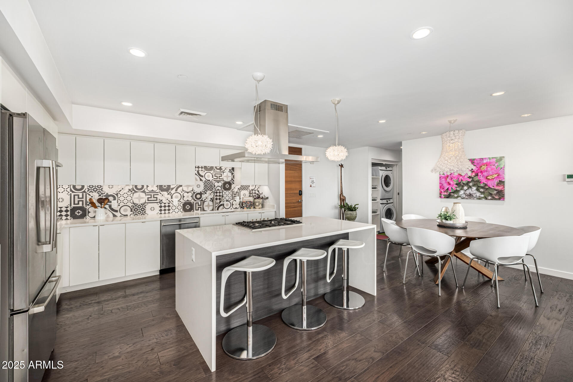 200 West Portland Street, Unit 827 Phoenix, AZ 85003 - Photo 8 of 111 a kitchen with stainless steel appliances kitchen island granite countertop a table chairs sink and cabinets