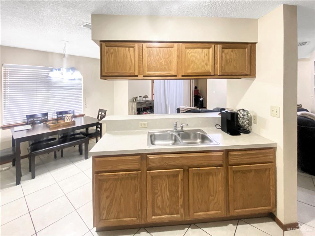 483 Whalen Road San Benito, TX 78586 - Photo 3 of 10 a kitchen with a sink cabinets and utility