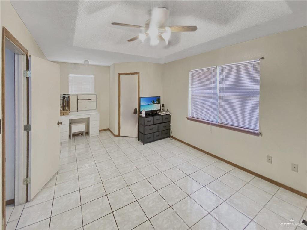 483 Whalen Road San Benito, TX 78586 - Photo 9 of 10 a view of a livingroom with furniture and cabinet a chandelier