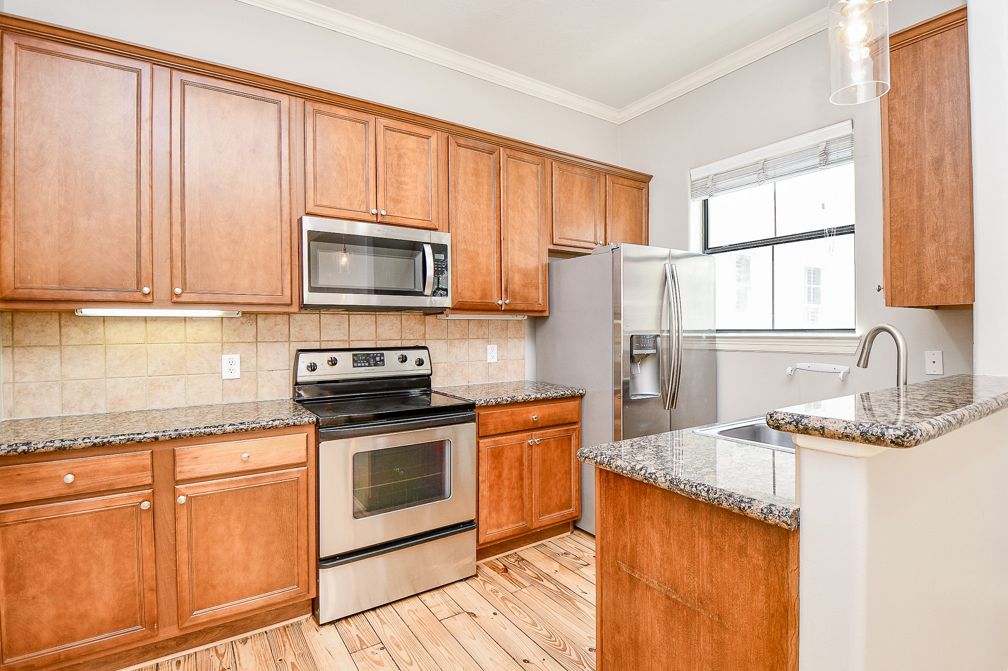 118 McGowen Street, Unit K Houston, TX 77006 - Photo 12 of 32 Open concept style kitchen ample cabinet space pantry granite counters and lots of natural light