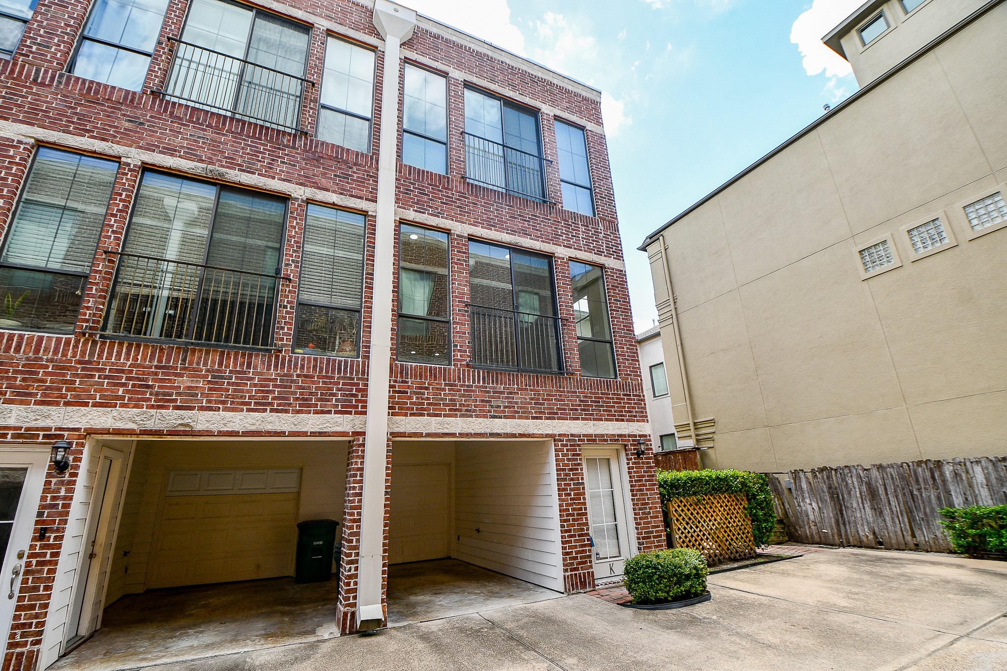 118 McGowen Street, Unit K Houston, TX 77006 - Photo 4 of 32 Beautiful brick exterior with one car garage plus an additional car covered porch area next the community common area.