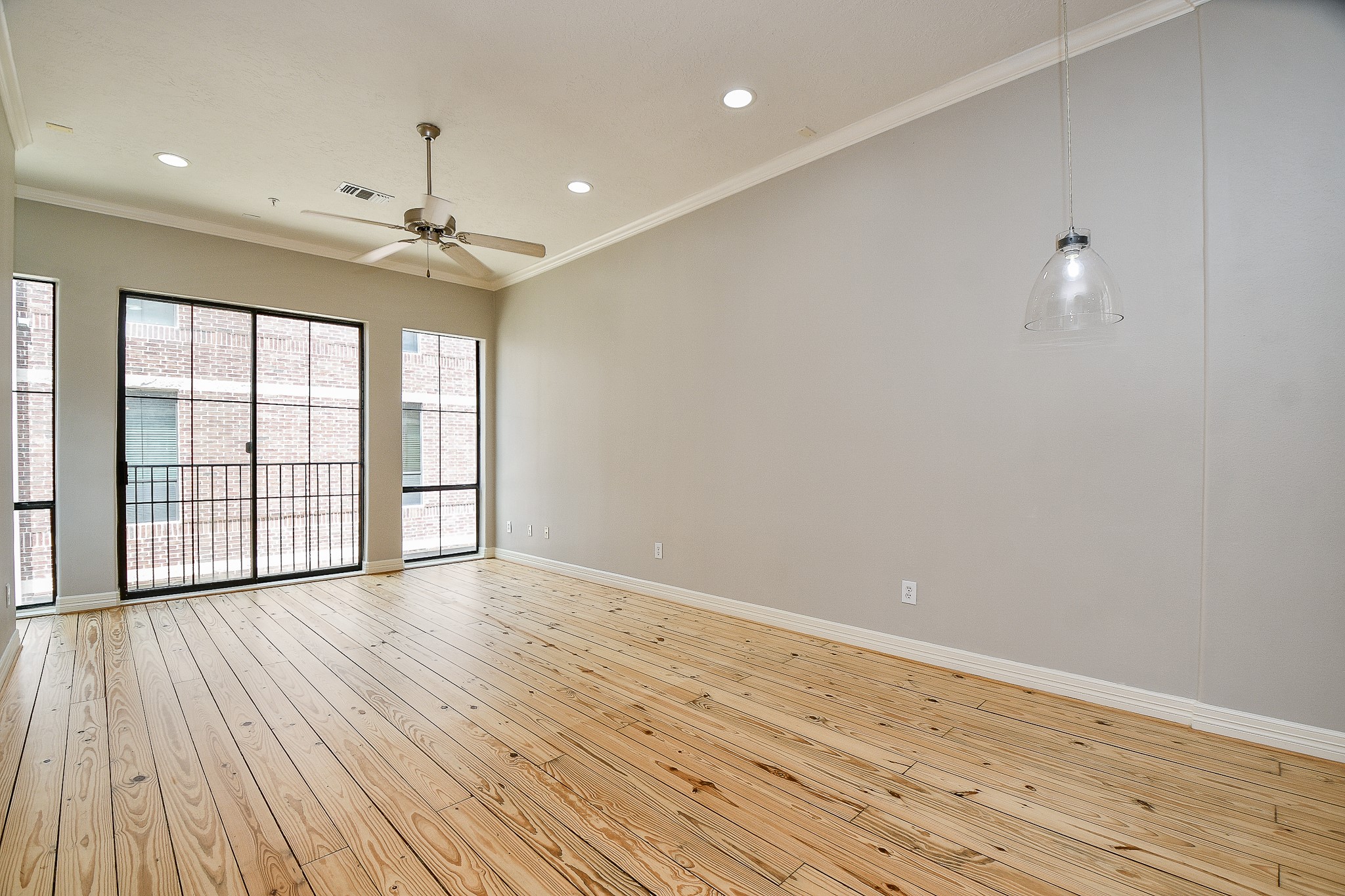 118 McGowen Street, Unit K Houston, TX 77006 - Photo 7 of 32 Beautiful Pine wood floors in the living room with high ceilings cannister lights and lots of natural light