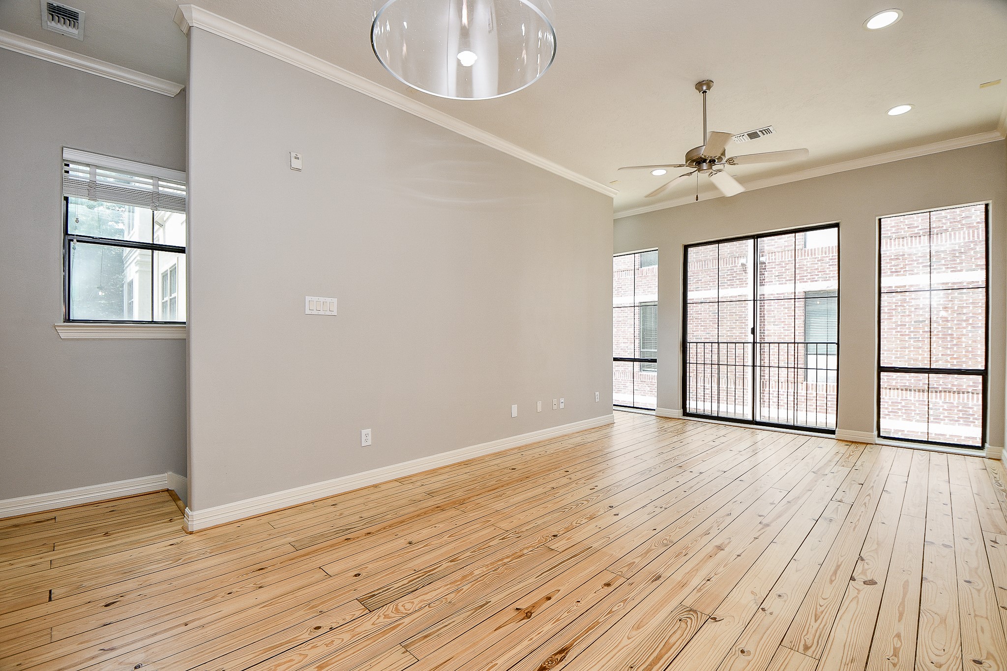 118 McGowen Street, Unit K Houston, TX 77006 - Photo 8 of 32 Beautiful Pine wood floors in the living room with high ceilings cannister lights and lots of natural light