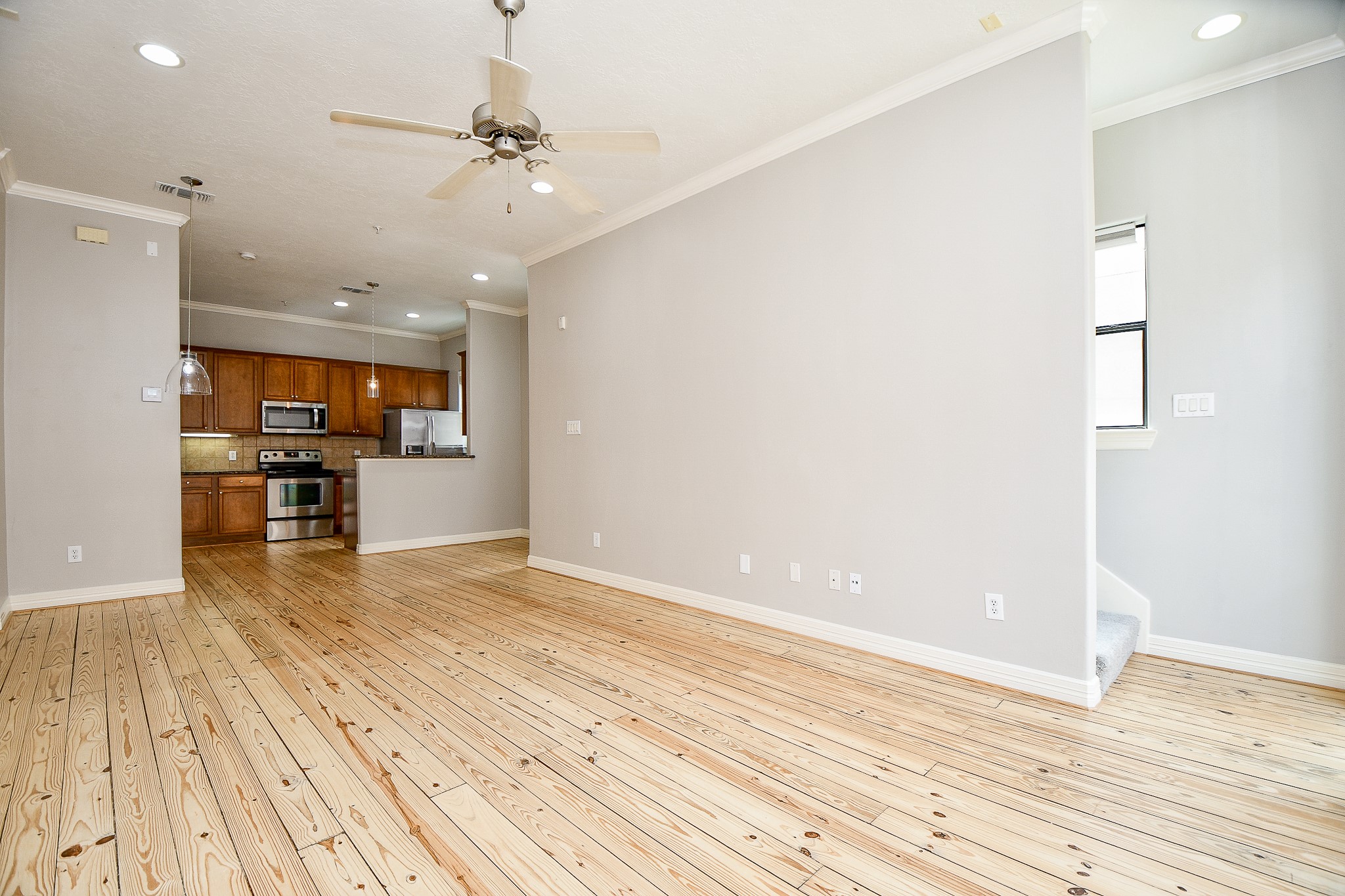 118 McGowen Street, Unit K Houston, TX 77006 - Photo 9 of 32 True open concept design with beautiful Pine wood floors in the living room with high ceilings cannister lights and lots of natural light